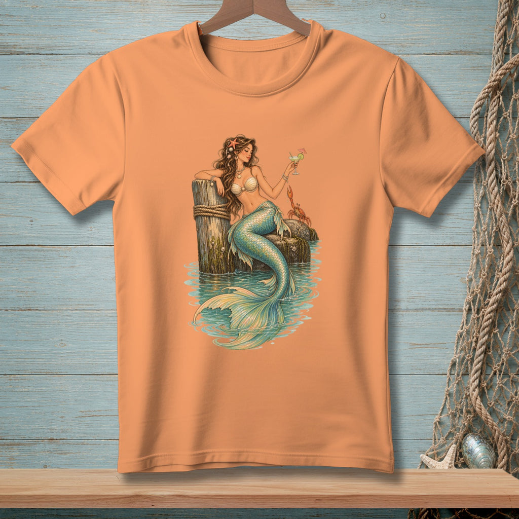 Orange t-shirt with a mermaid holding a drink next to a crab.