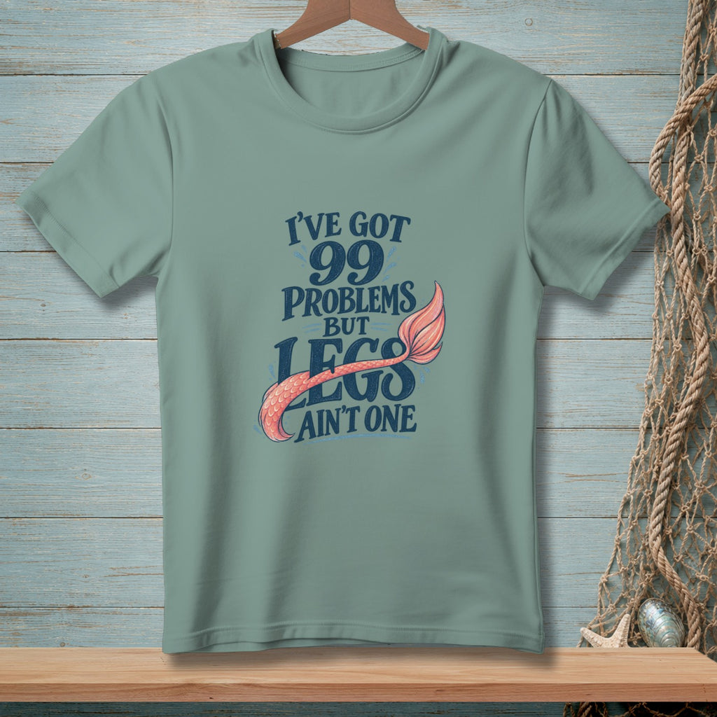 Green t-shirt with "I've got 99 problems but legs ain't one" text and mermaid tail graphic.