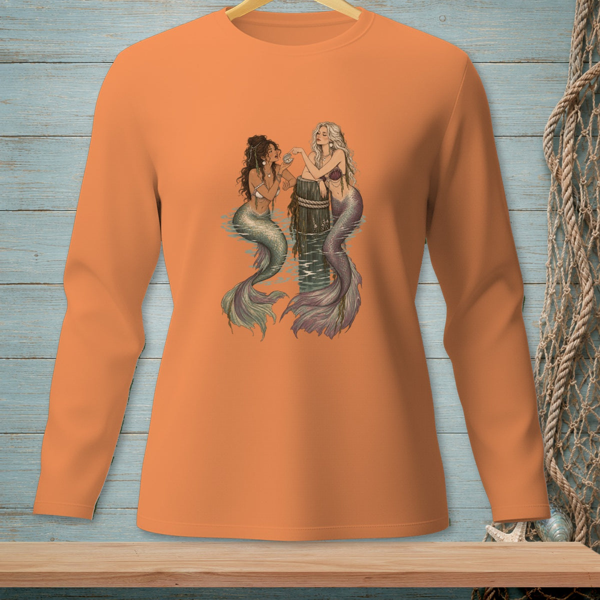 Two mermaids with colorful tails sit on a weathered post in the water.