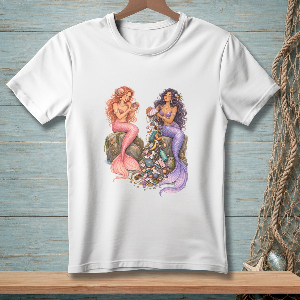 Two mermaids sitting on rocks with a pile of collected treasures.