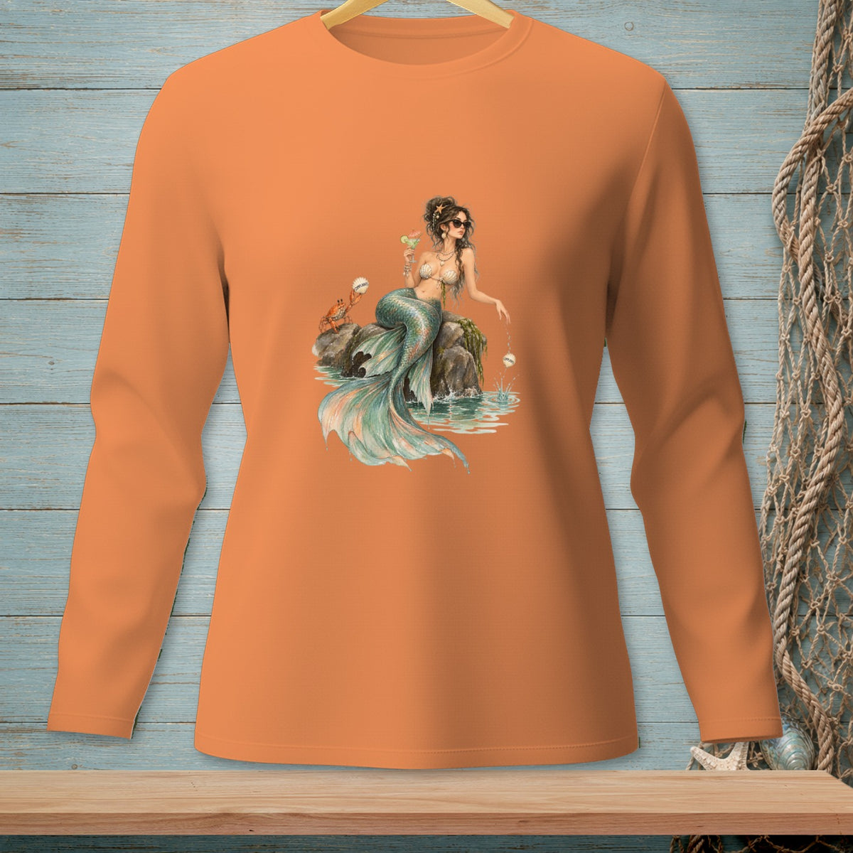 Orange long-sleeve shirt with a watercolor-style mermaid and crab graphic.