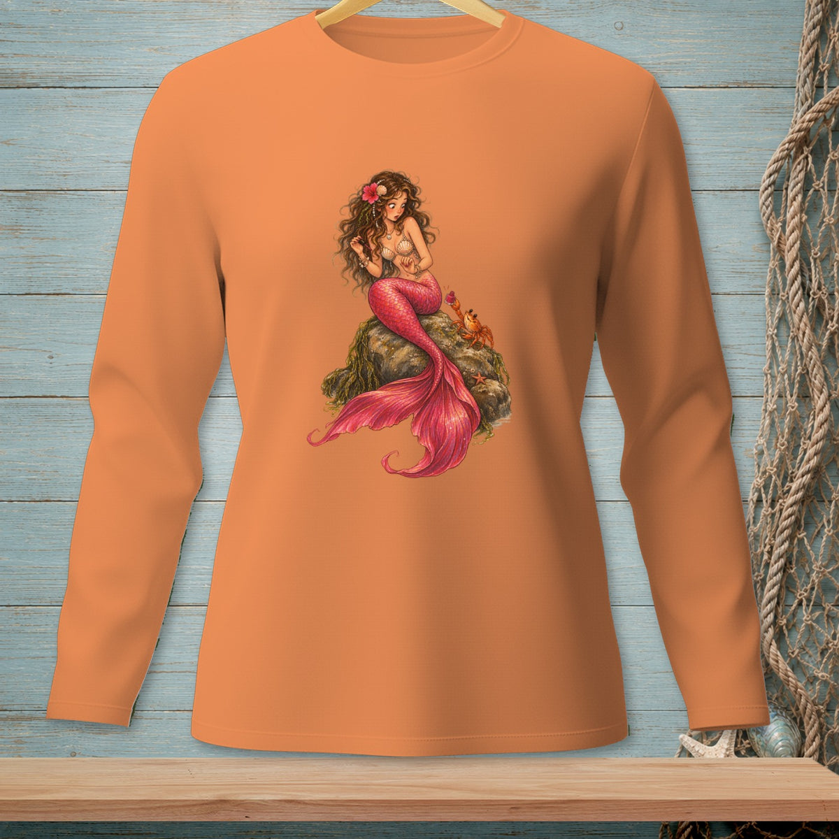 Long sleeve orange shirt with a detailed mermaid graphic and a small crab.