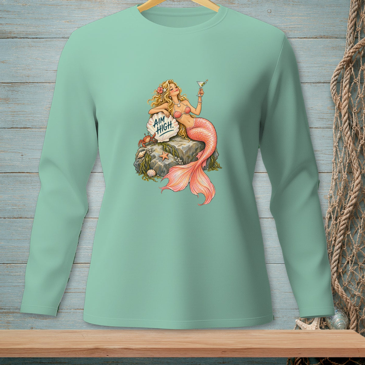 Mint green long-sleeve shirt with a mermaid graphic saying "AIM HIGH".