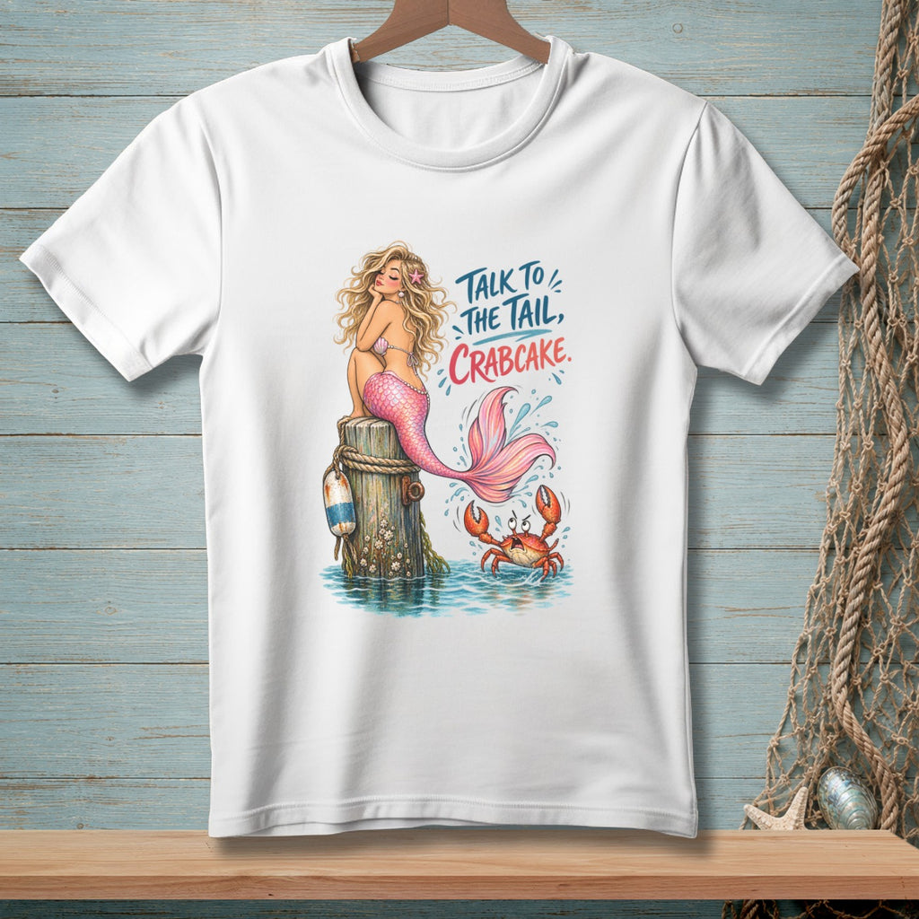 White t-shirt with illustration of mermaid, crab, and text: Talk to the tail, crabcake.