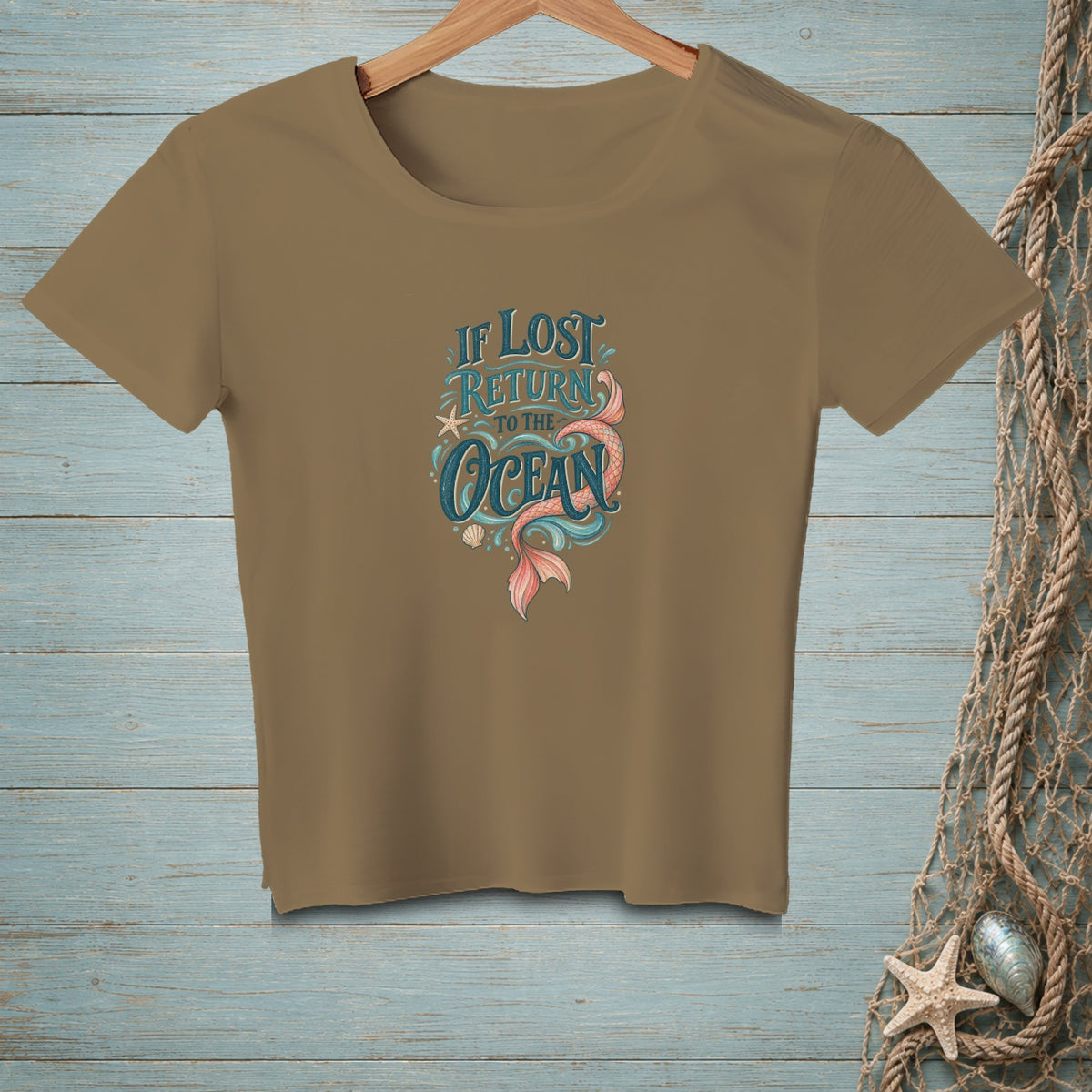 Tan t-shirt with "If Lost Return to the Ocean" text and mermaid tail graphic.