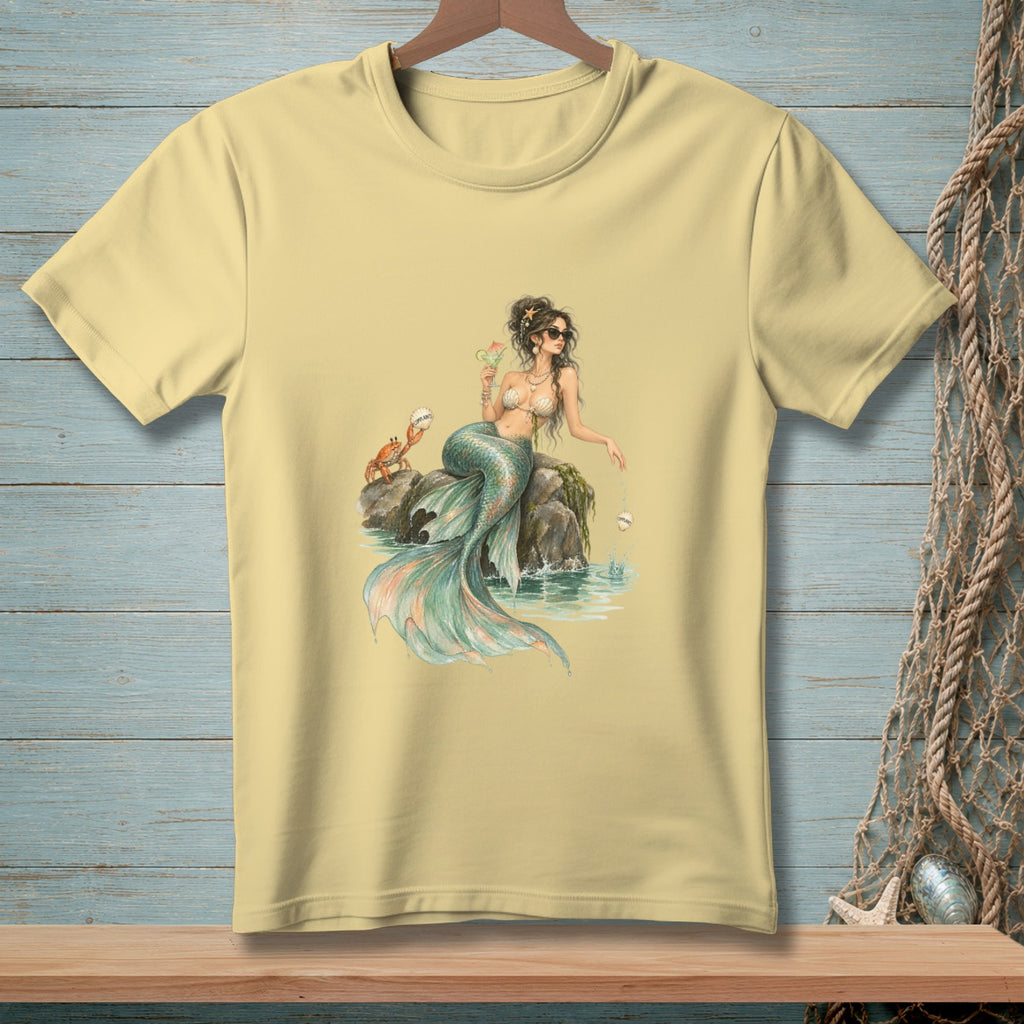 Light yellow t-shirt with a watercolor illustration of a mermaid, crab, and seashells.