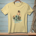 Light yellow t-shirt with a watercolor illustration of a mermaid, crab, and seashells.