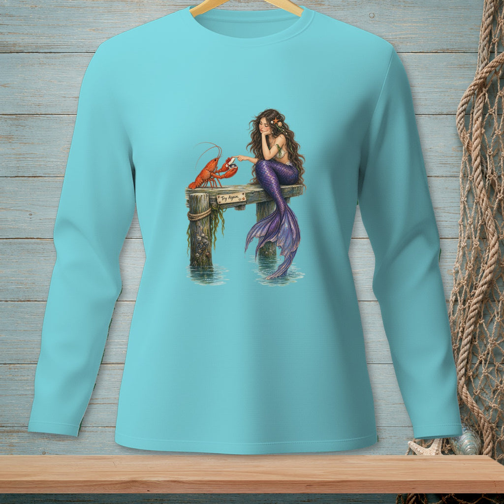 Mermaid with purple tail sits on dock with lobster and sign "Try Again."
