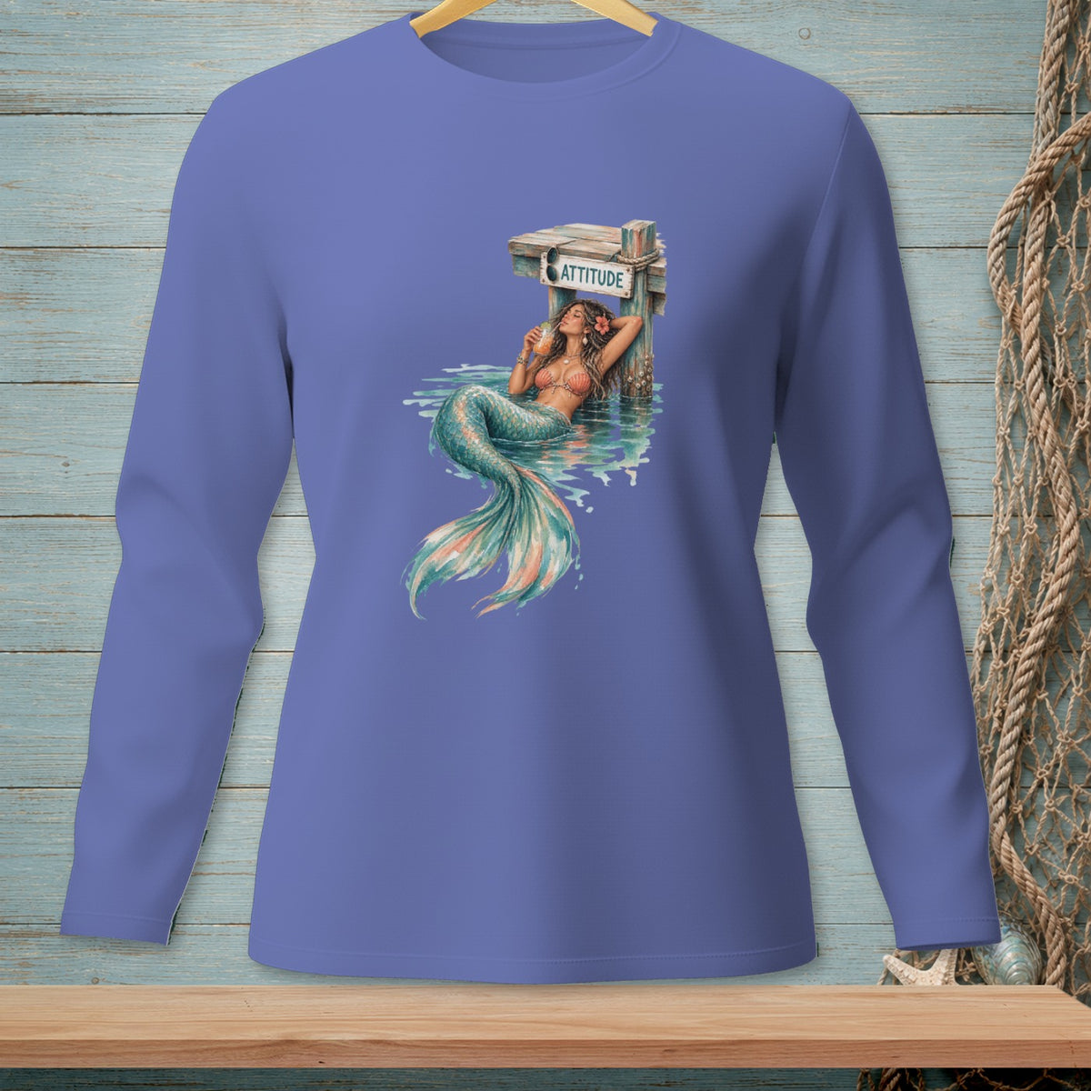 Mermaid lounging by dock with drink, "ATTITUDE" sign and sunglasses.