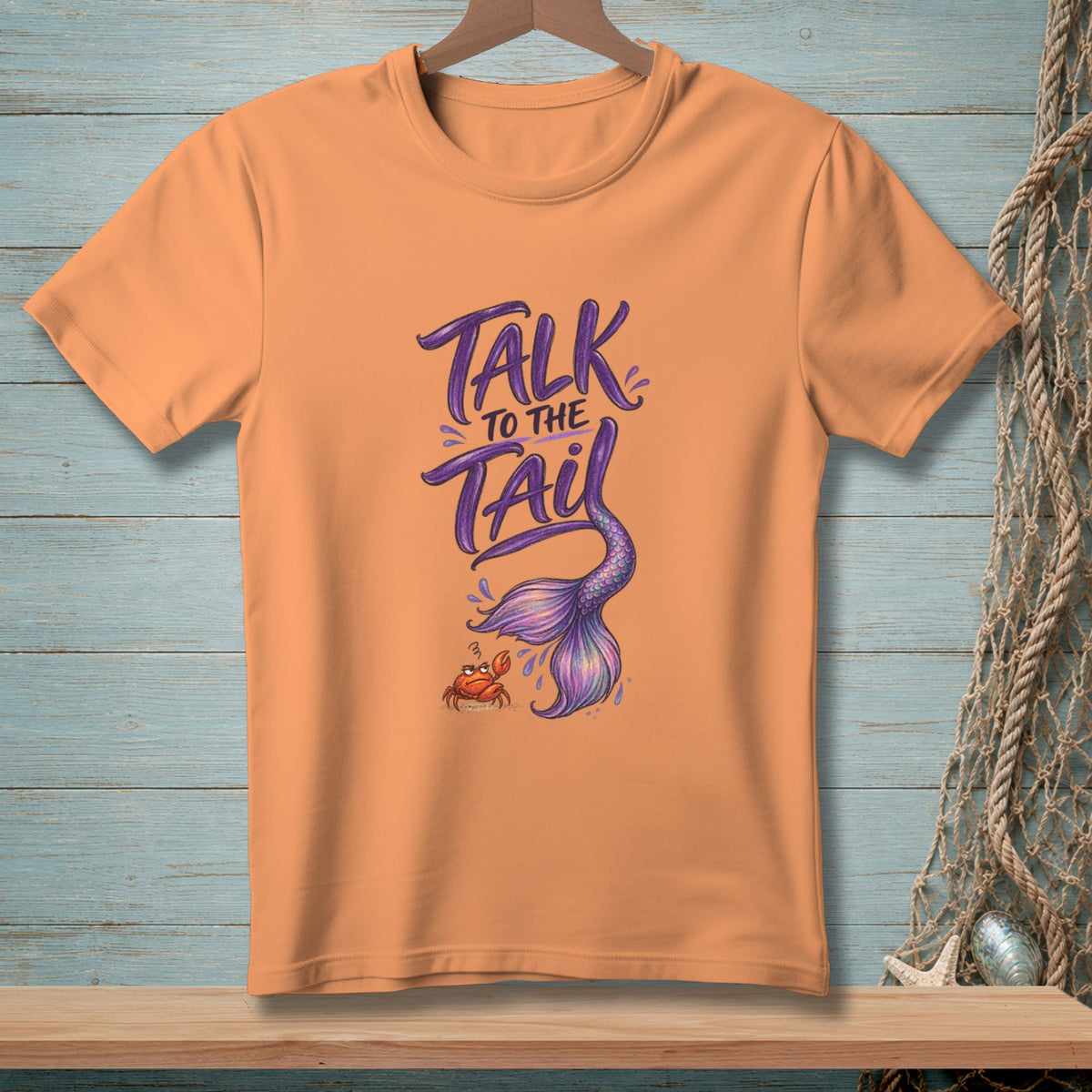 Orange t-shirt with "Talk to the Tail" text, mermaid tail, and crab graphic.