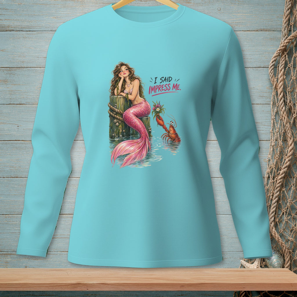 Mermaid with pink tail rests on pier, lobster offers flowers, text reads "I SAID IMPRESS ME."