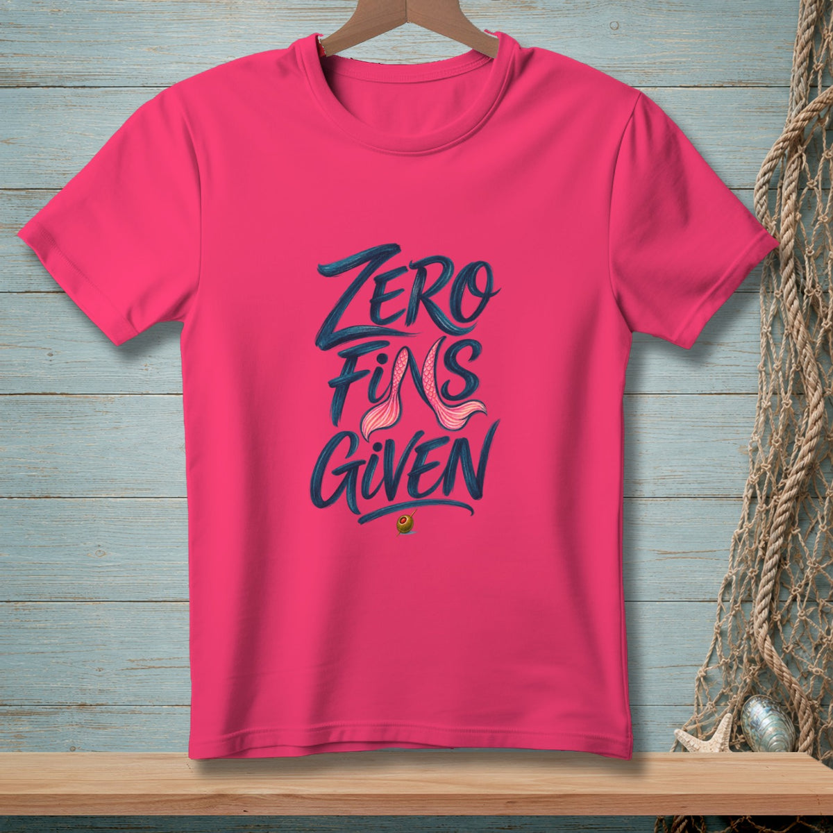 Pink t-shirt with "ZERO FINS GIVEN" text and mermaid tail graphic.