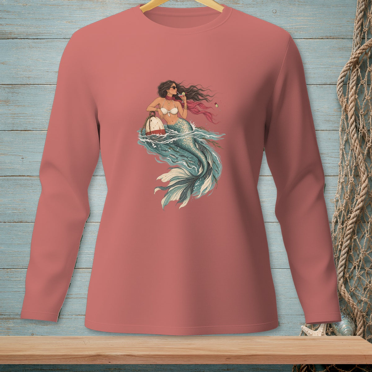 Mermaid with cocktail and buoy graphic on coral long-sleeve shirt.