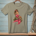 Brown-haired mermaid with pink tail sits on a rock with a crab and starfish.