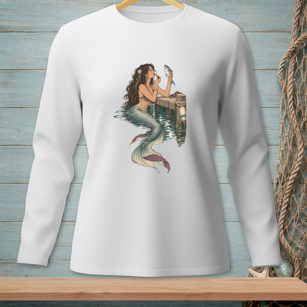 Illustration of a mermaid applying makeup with a fish on a pier.