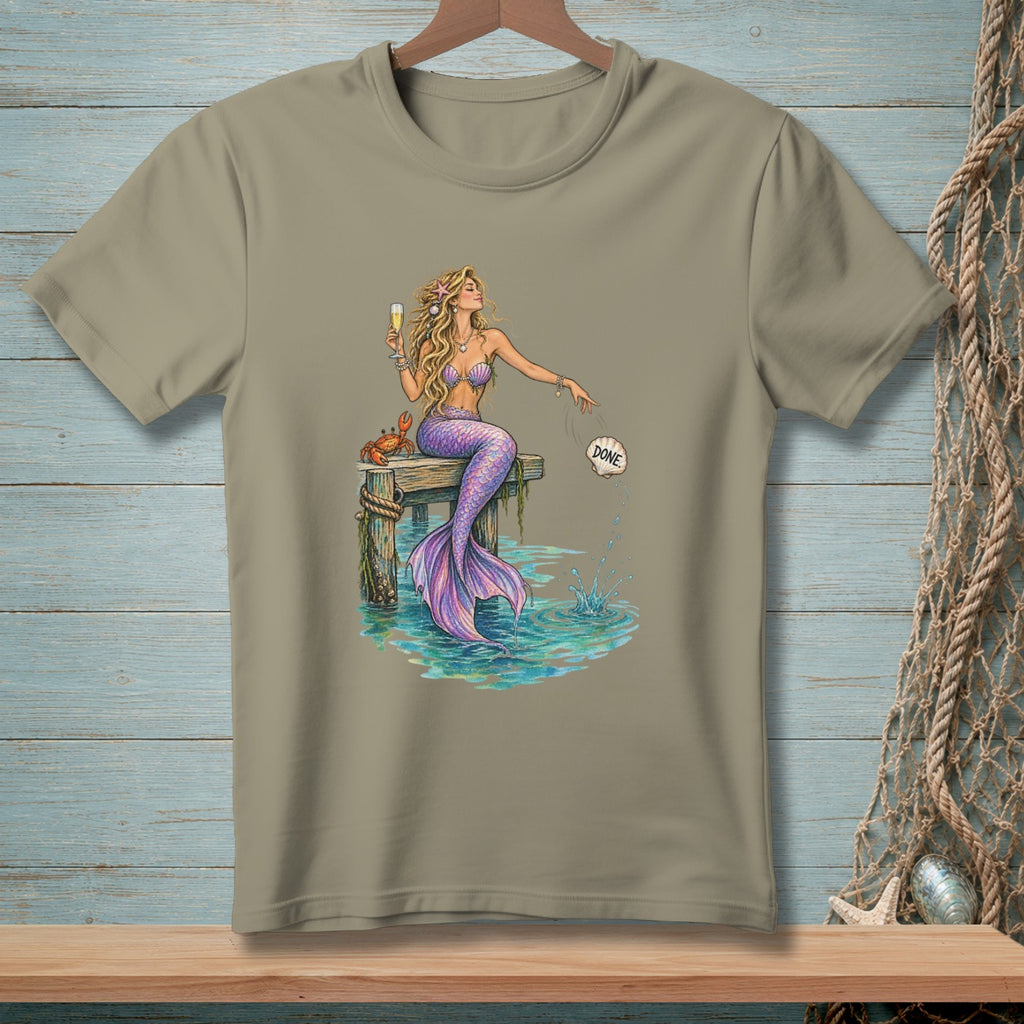 Mermaid with purple tail sits on dock, holding champagne, with a crab and a shell labeled "DONE".