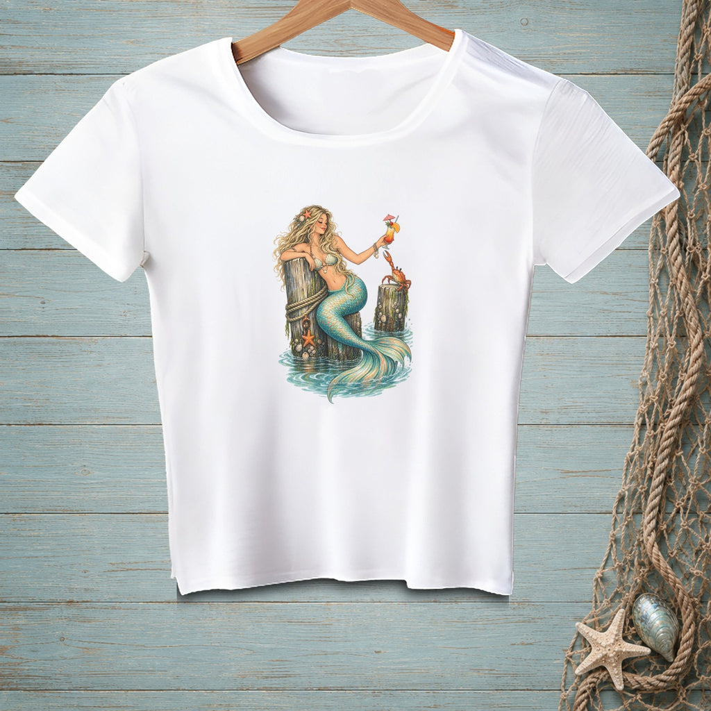 White t-shirt with illustration of a mermaid holding a drink on a wooden post.