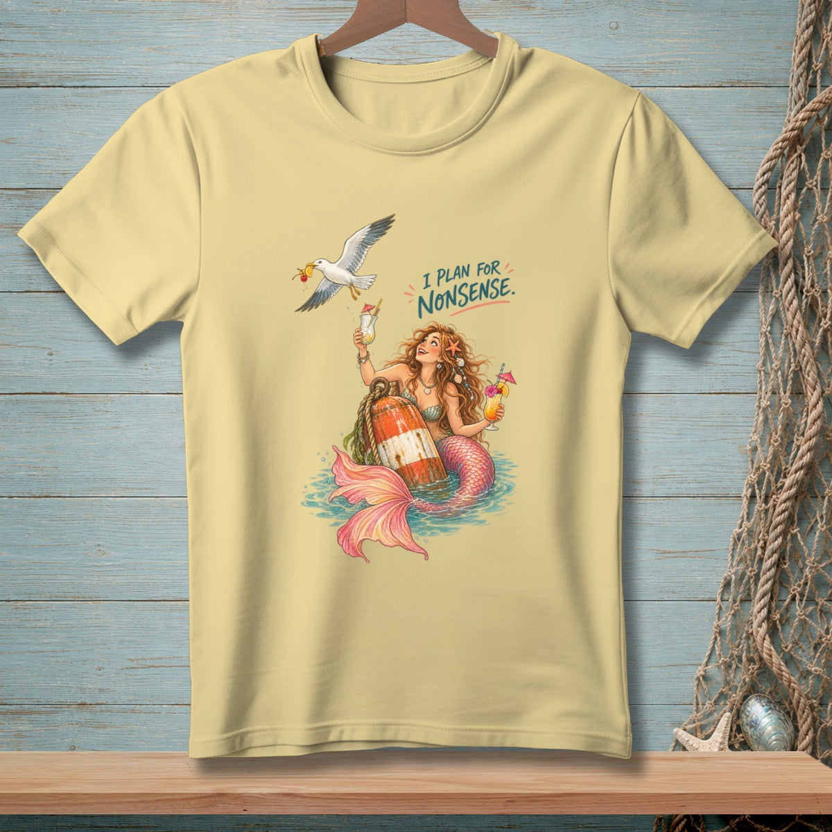 Yellow t-shirt with mermaid and seagull design, saying "I PLAN FOR NONSENSE."
