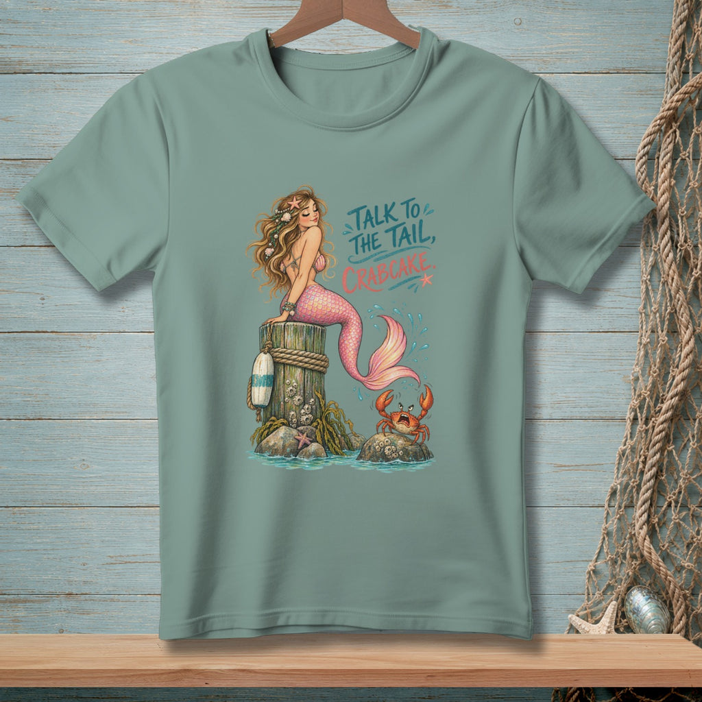 Mermaid sitting on a post with a crab, text says "Talk to the tail, Crabcake."