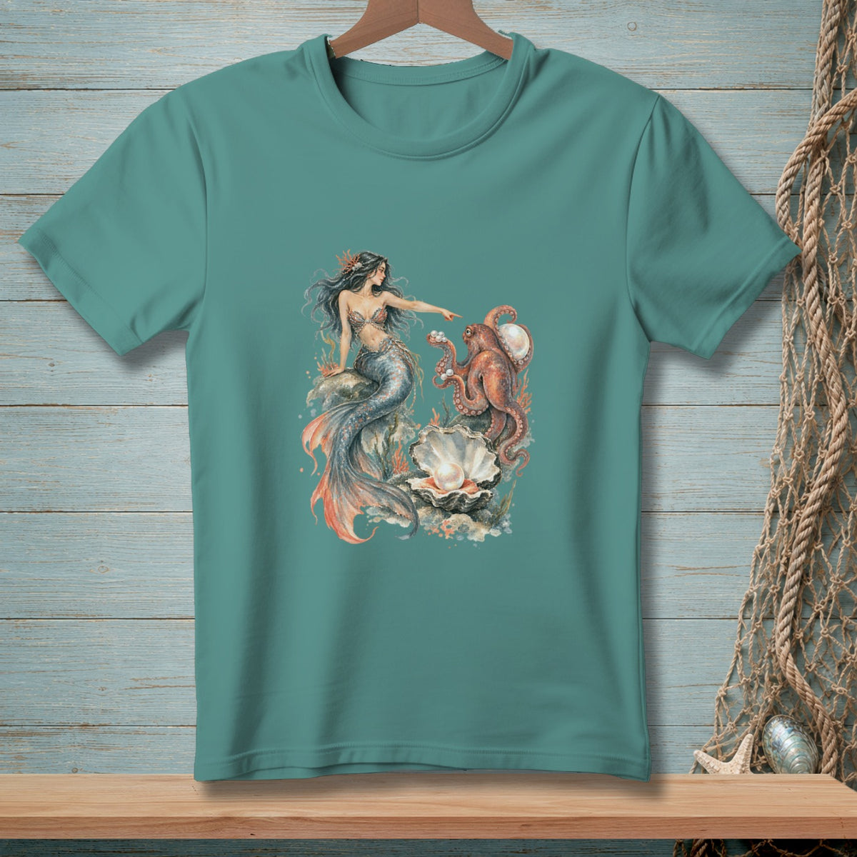 Teal t-shirt with a print of a mermaid and an octopus near a large pearl.