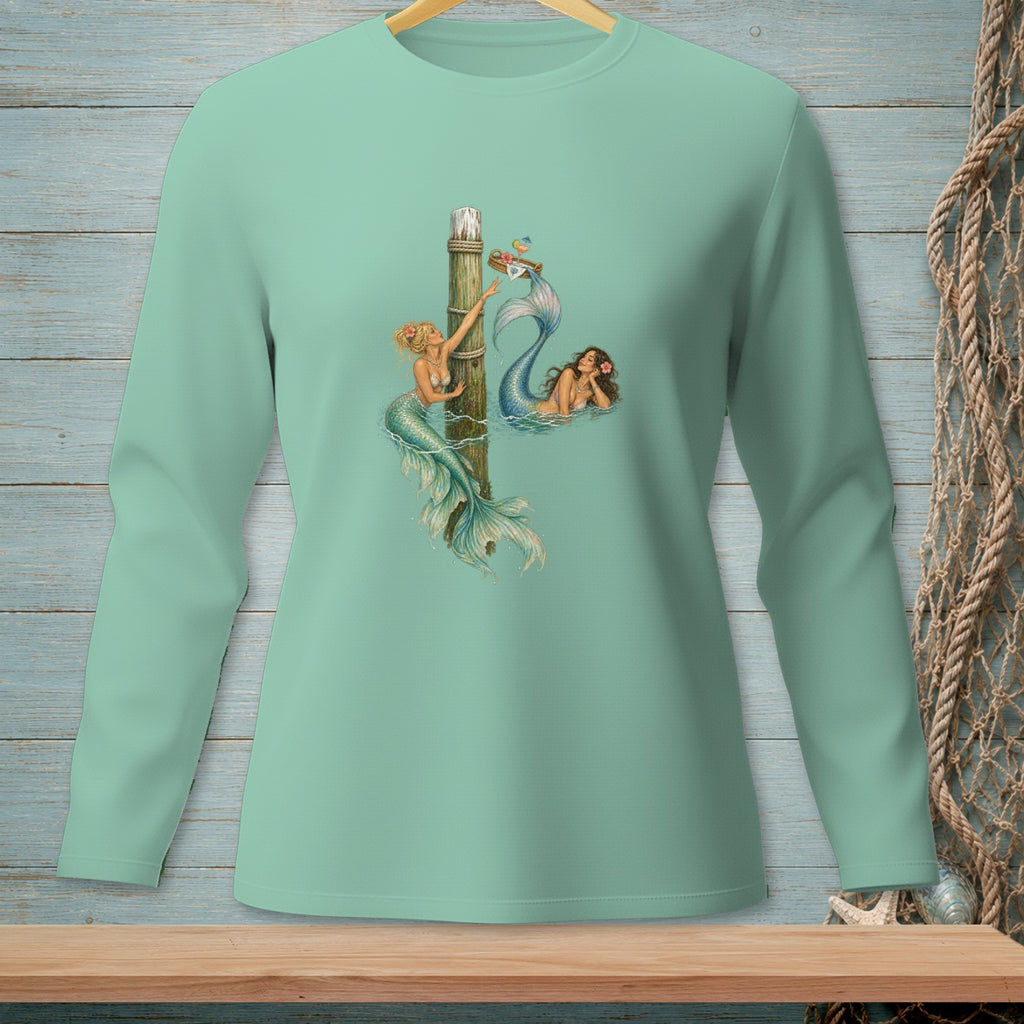 Mint long sleeve shirt with two mermaids and a wooden post design.