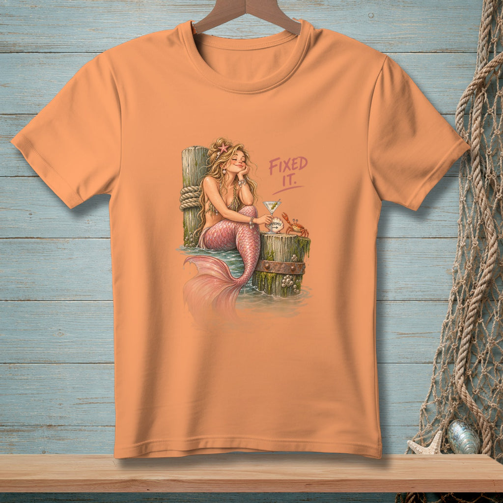 Orange t-shirt with mermaid, martini, crab, and text "FIXED IT."