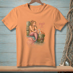 Orange t-shirt with mermaid, martini, crab, and text "FIXED IT."