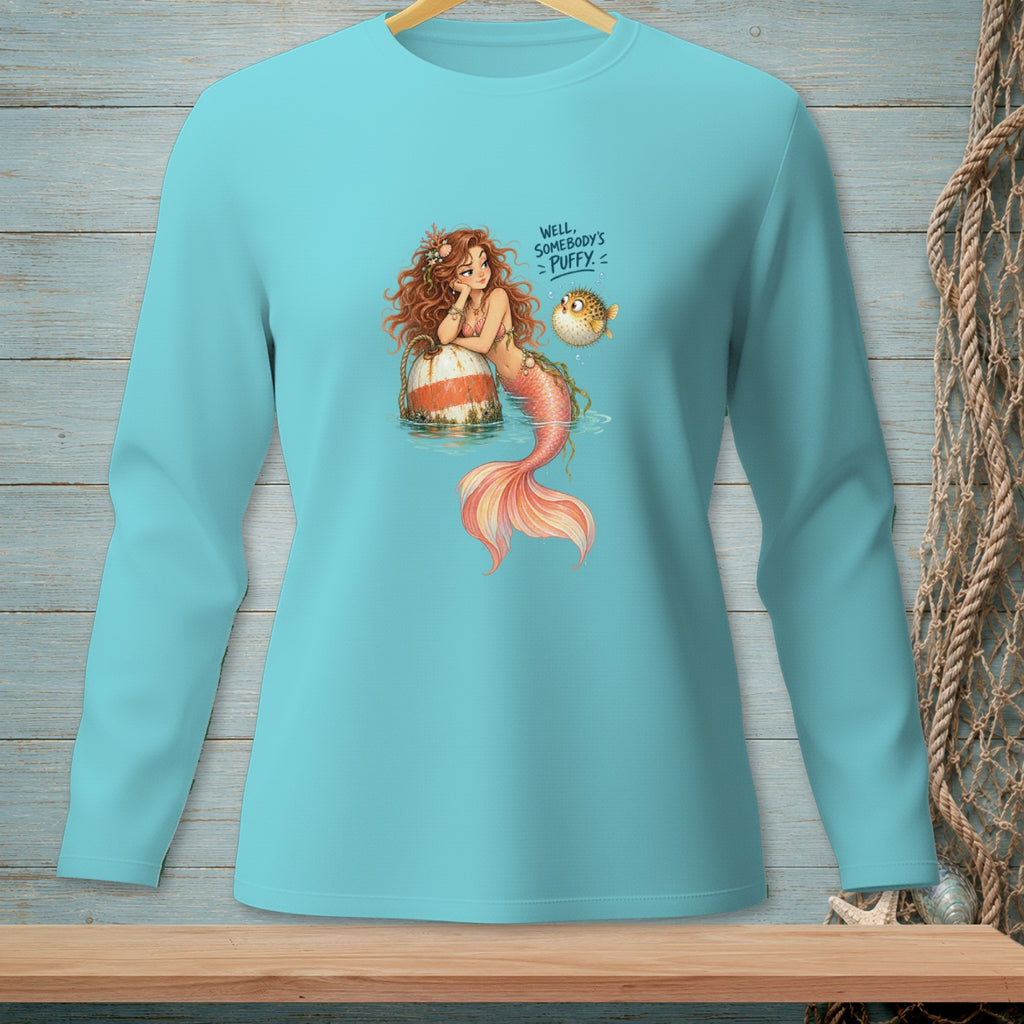 Mermaid with pufferfish and text "WELL, SOMEBODY'S PUFFY" on a teal long-sleeve shirt.
