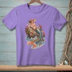 Purple t-shirt with a graphic of a mermaid sitting on a rock surrounded by crabs and waves.