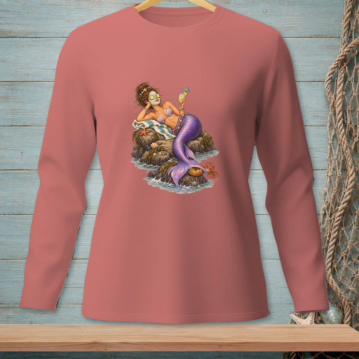Mermaid with face mask and cocktail relaxing on rocks with a crab.