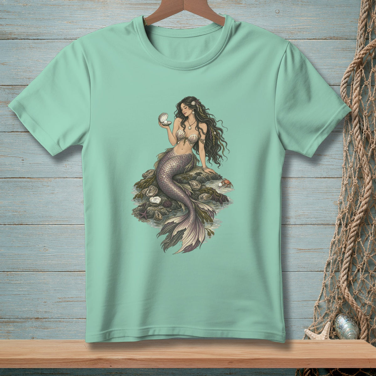 Mermaid holding a pearl, sitting on rocks with oysters and a crab.