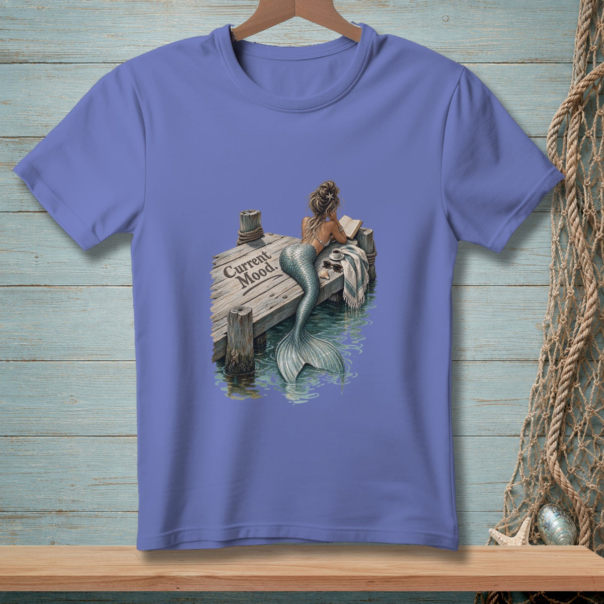 Mermaid reading on dock, with text "Current Mood."