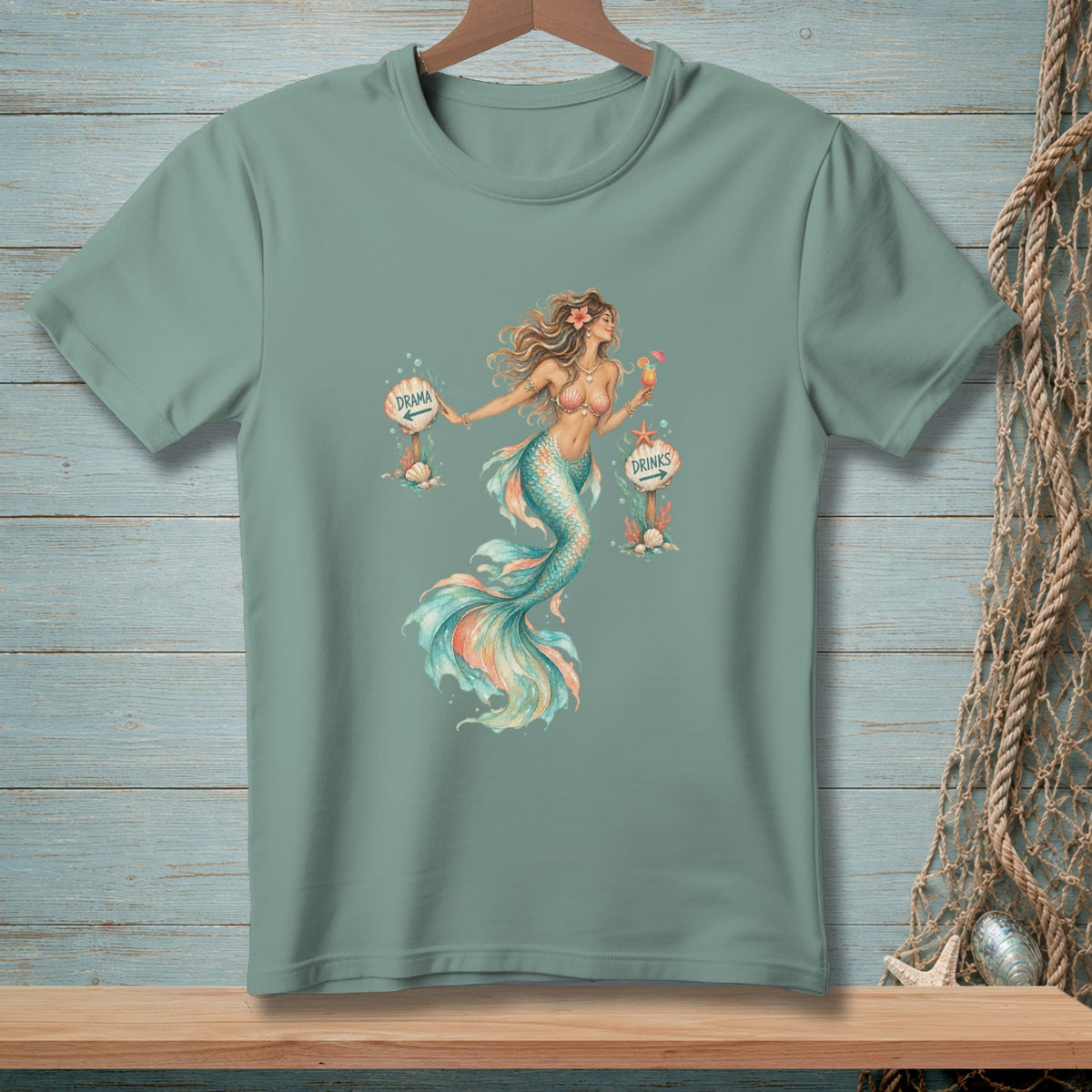 T-shirt graphic with a mermaid holding a drink between signs pointing to "Drama" and "Drinks."