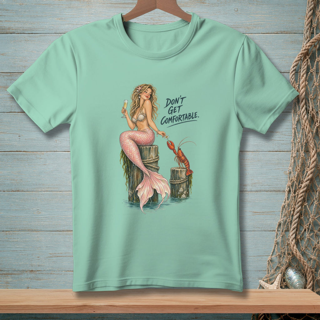 Mermaid with champagne and lobster, text reads "Don't Get Comfortable."