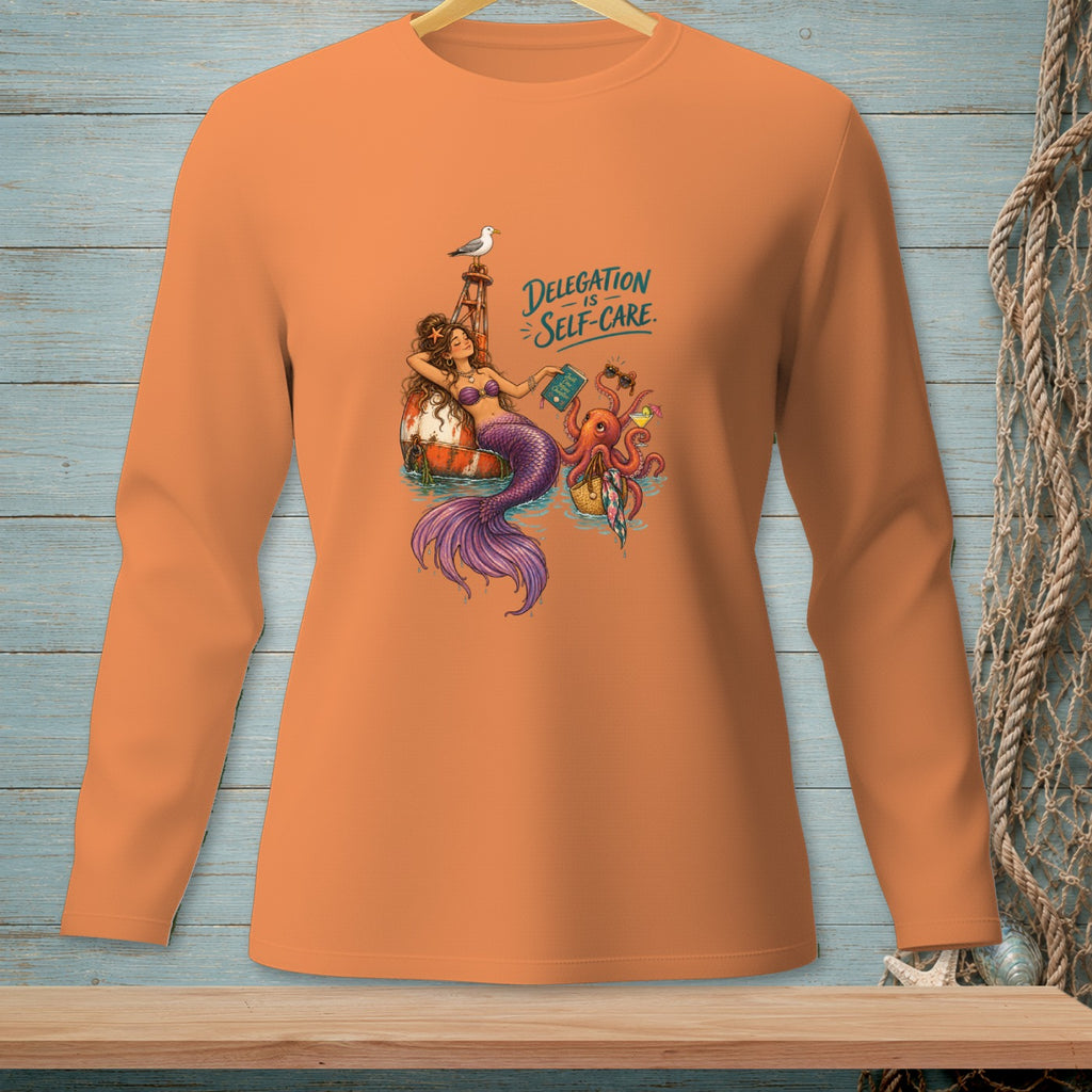 Mermaid, octopus, and seagull with text "Delegation is Self-Care" on orange shirt.