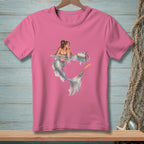 Pink t-shirt with a watercolor illustration of a mermaid relaxing by a cooler of drinks.