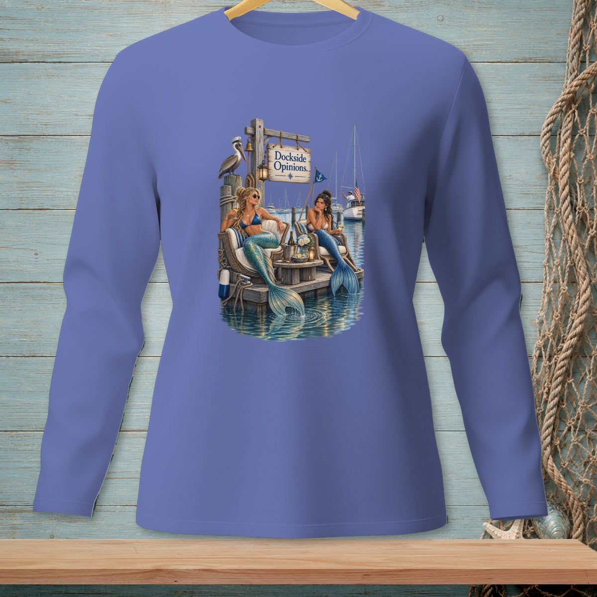 Long-sleeve shirt with two mermaids on a dock, a pelican, and a sign reading "Dockside Opinions."