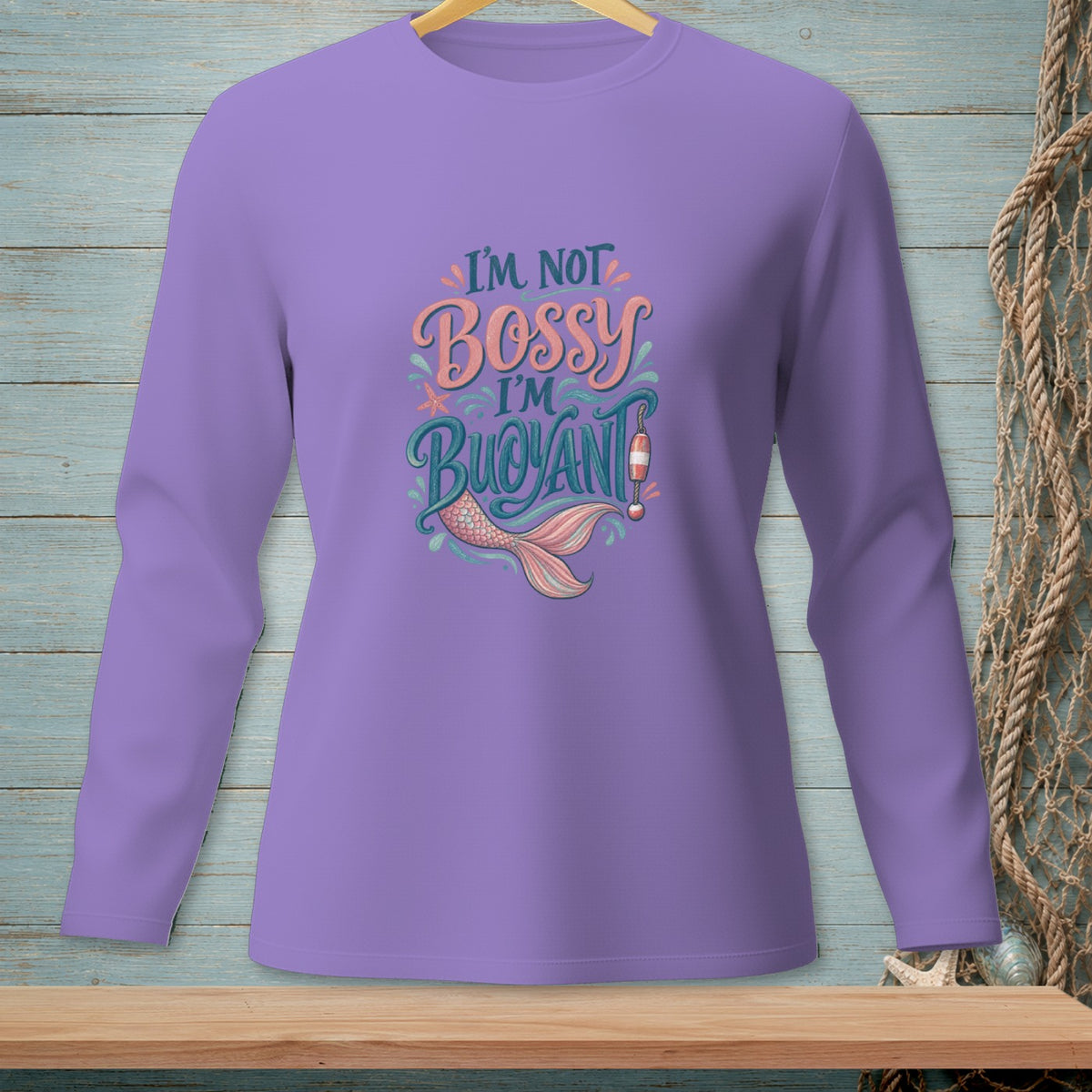 Purple long-sleeve shirt with "I'm not bossy, I'm buoyant" and mermaid tail graphic.
