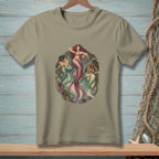 T-shirt graphic with three mermaids in an oval design with seaweed and rocks.