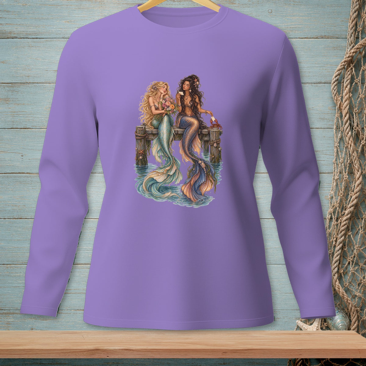 Two mermaids with colorful tails sit on a dock, one holding flowers, the other a drink.
