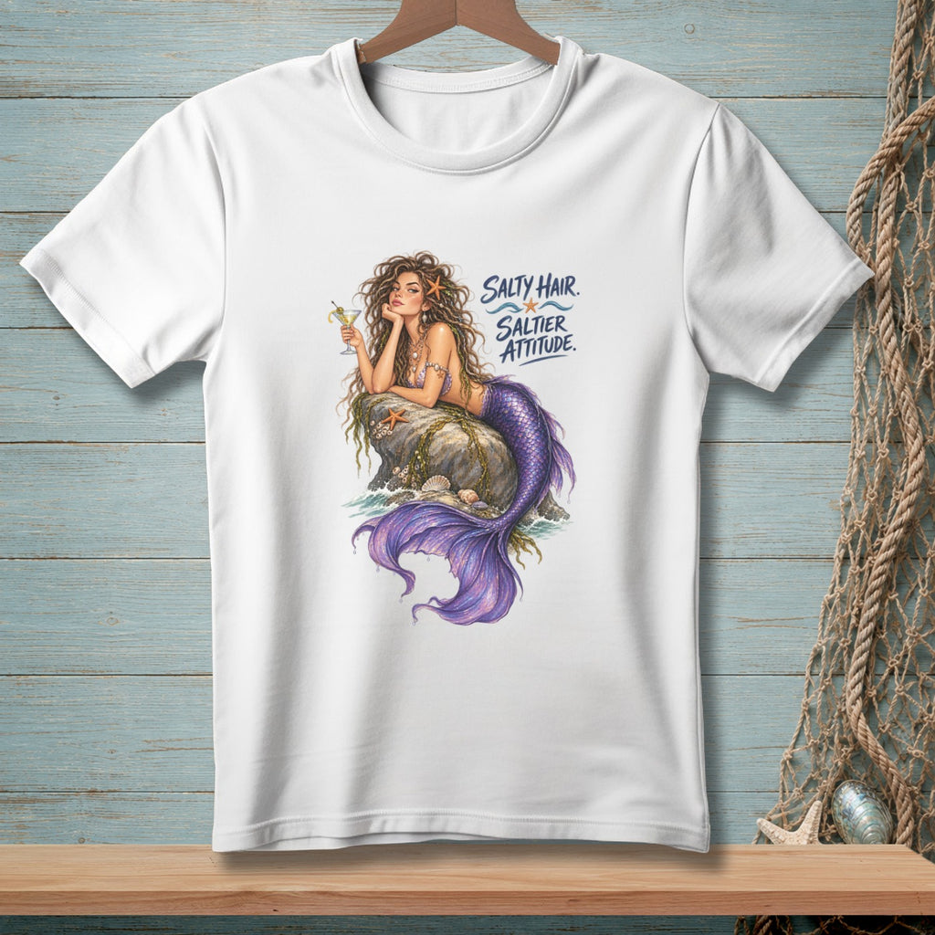 White t-shirt with a graphic of a mermaid holding a drink, resting on a rock.