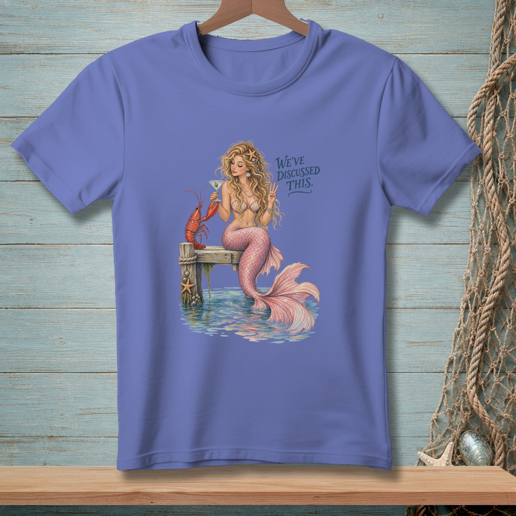 Mermaid with lobster and martini on dock, text "WE'VE DISCUSSED THIS."