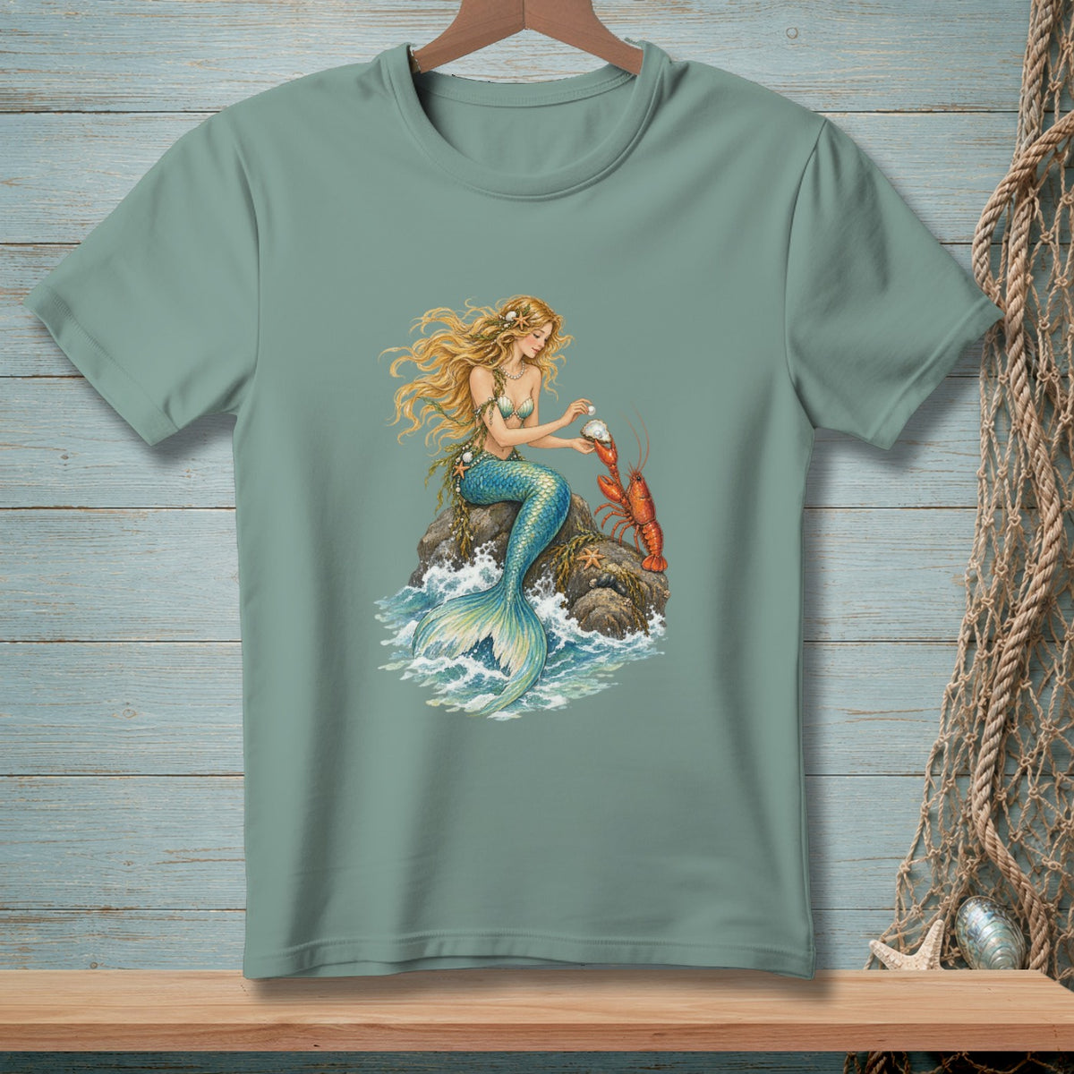 Mermaid with pearl and lobster on a rock, depicted on a t-shirt.