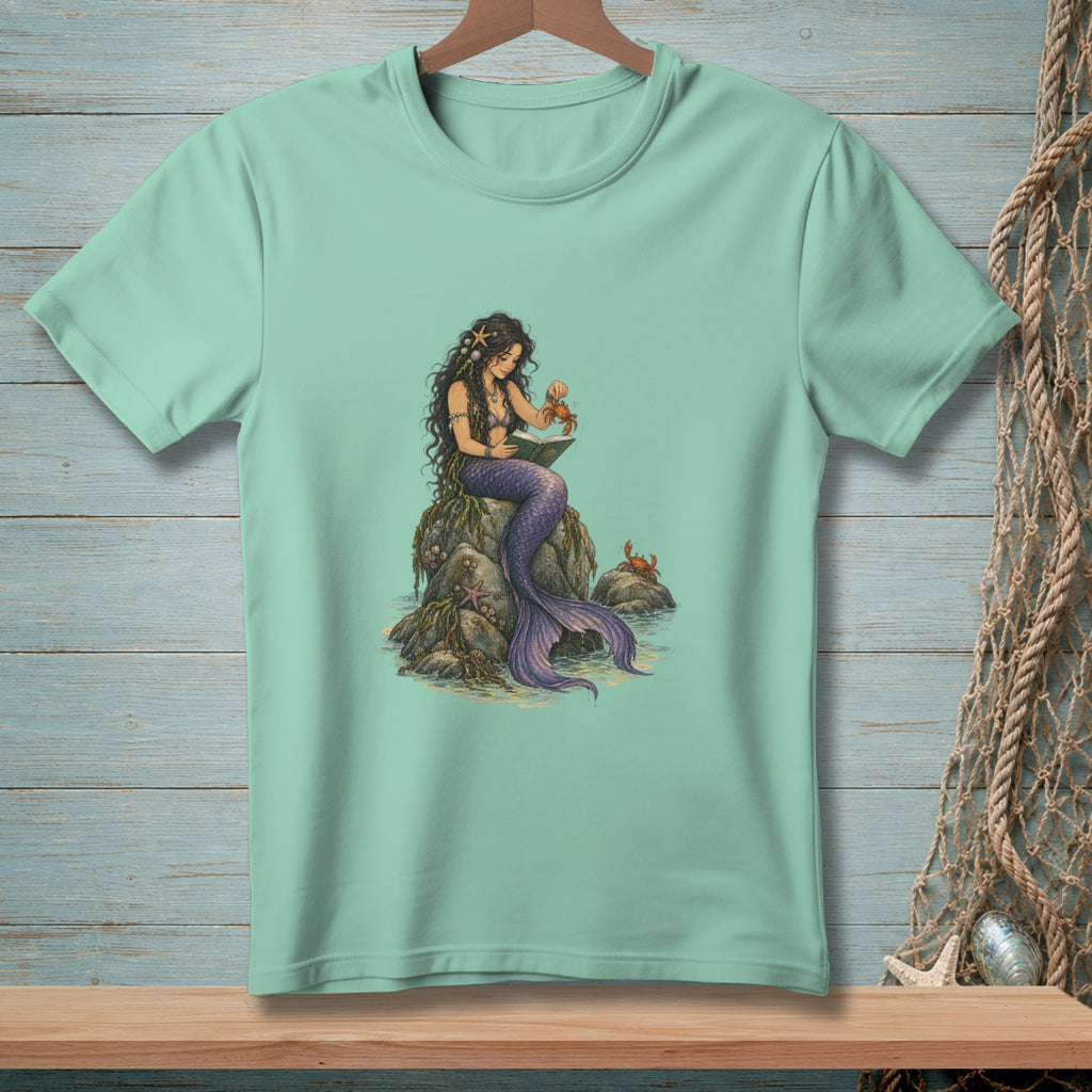 Mermaid with purple tail reading on a rock with crabs and starfish.