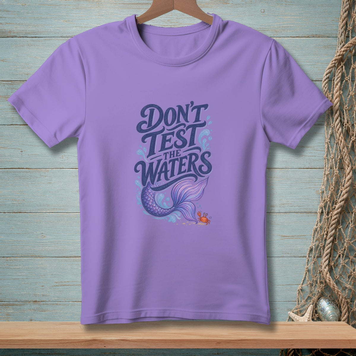 Purple t-shirt with "Don't Test the Waters" text, mermaid tail, and crab graphic.