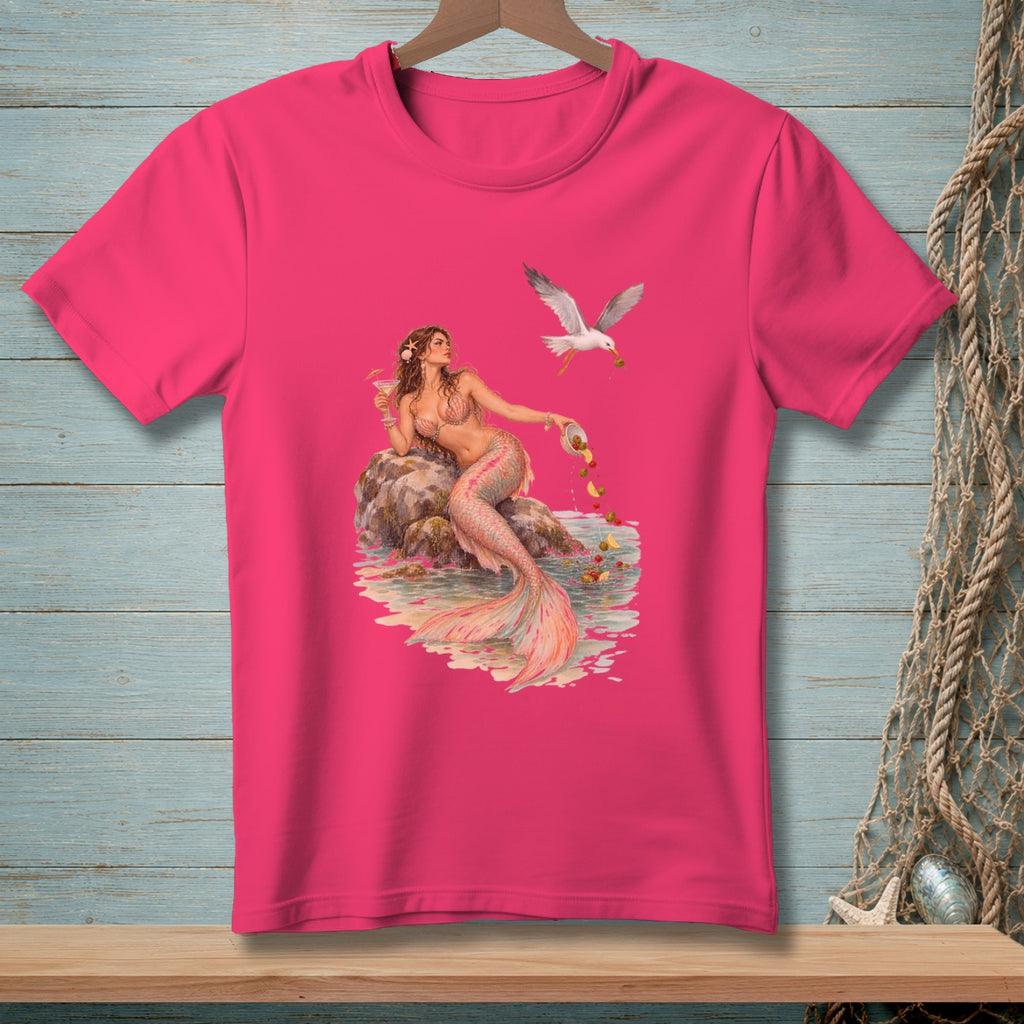 Pink t-shirt with a mermaid and a seagull dropping fruit into the water.