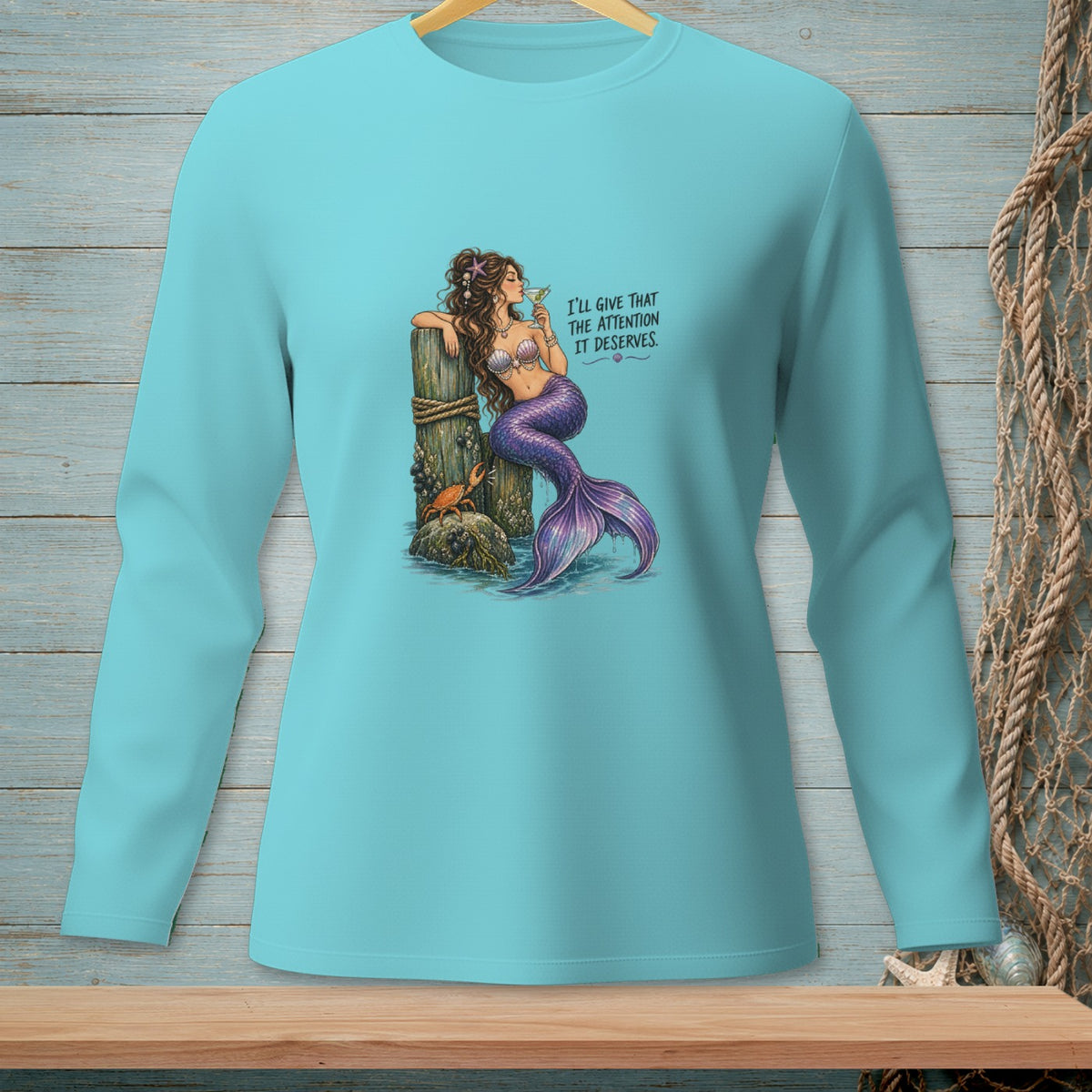 Light blue long-sleeve shirt with a mermaid graphic and text.