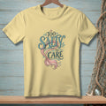 Pale yellow t-shirt with "Too Salty To Care" and a mermaid tail graphic.