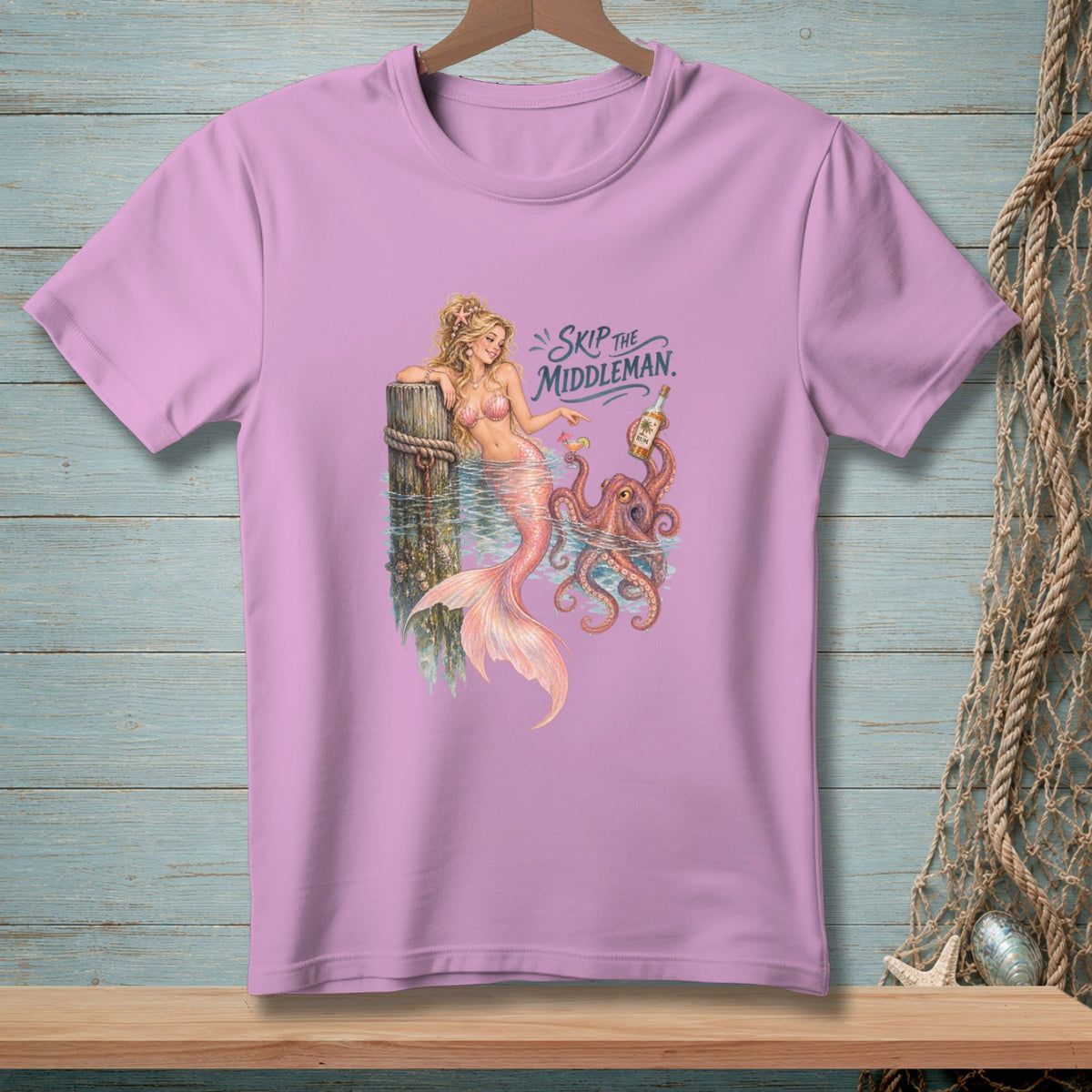Lavender t-shirt with a mermaid, octopus, and rum bottle graphic reading "Skip The Middleman".