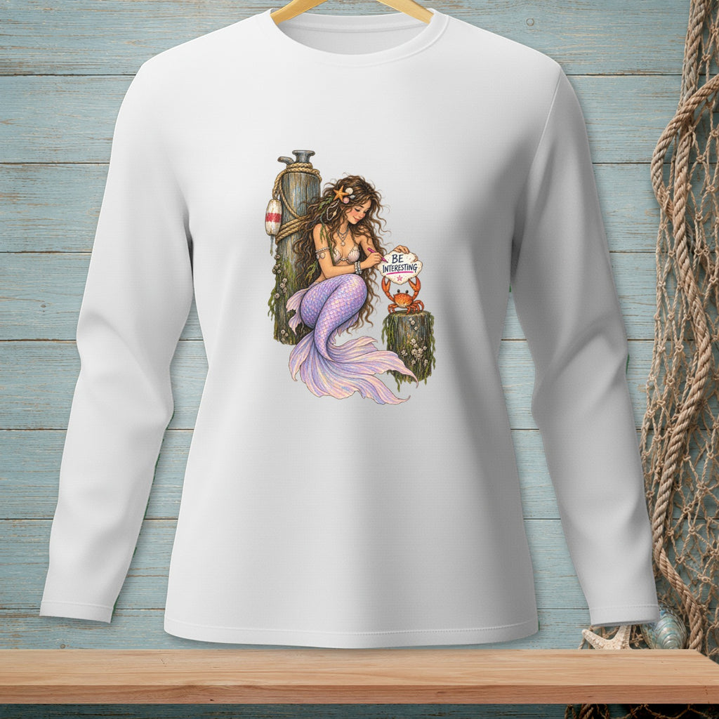 Mermaid sitting on a post holding a crab with "Be Interesting" sign.